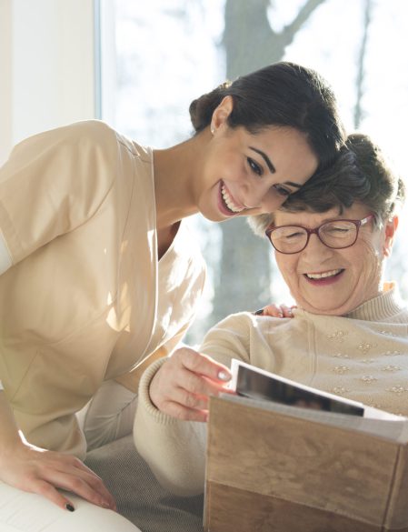 Smiling senior woman watching photobook